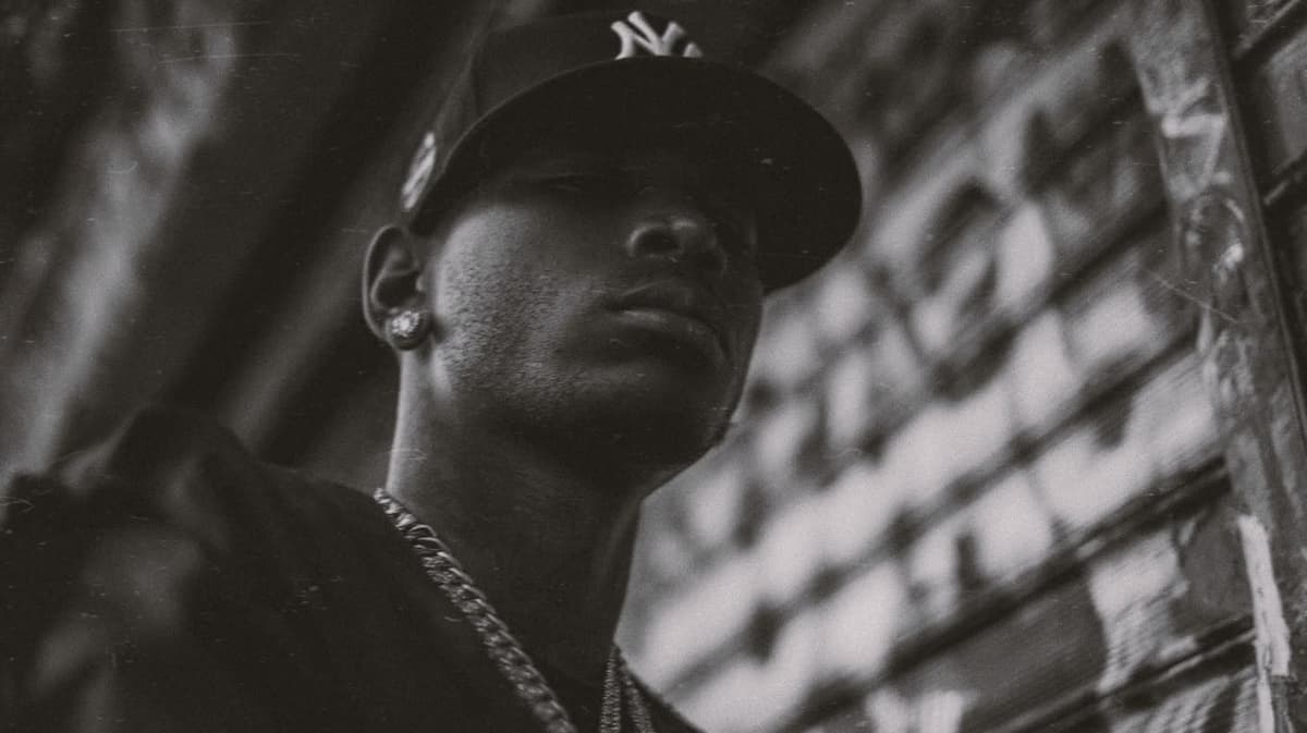 Collector in a New York cap against a graffiti wall