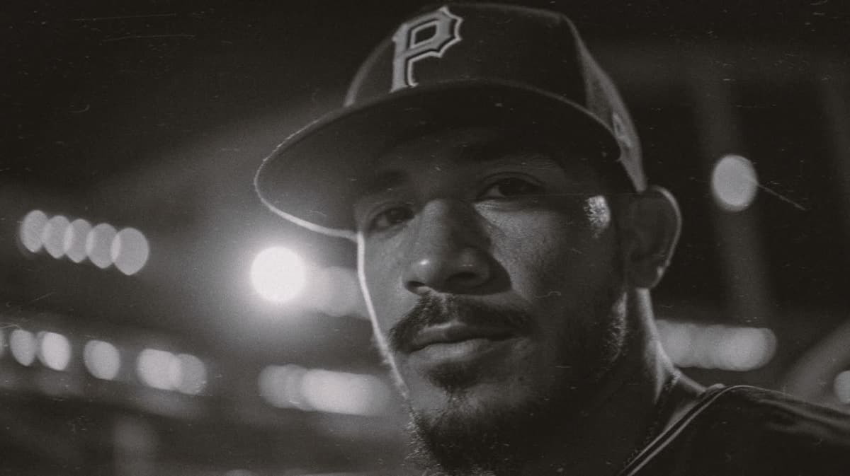 Collector in a Pittsburgh fitted cap at night